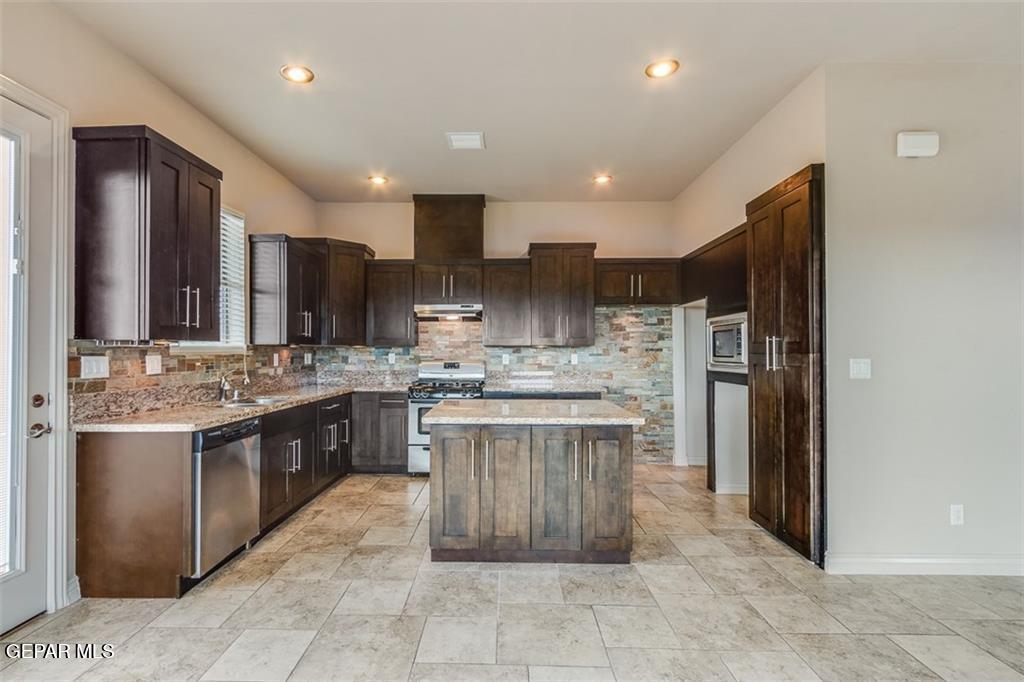 401 Ana Way, Unit B El Paso, TX 79912 - Photo 28 of 28 a kitchen with stainless steel appliances granite countertop a refrigerator oven a sink and dishwasher