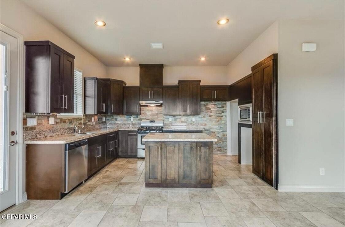 401 Ana Way, Unit B El Paso, TX 79912 - Photo 3 of 28 a kitchen with kitchen island stainless steel appliances a sink stove and refrigerator