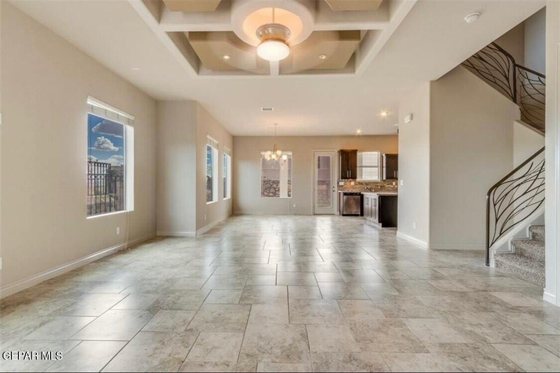 401 Ana Way, Unit B El Paso, TX 79912 - Photo 4 of 28 a view of an empty room with a kitchen and a window