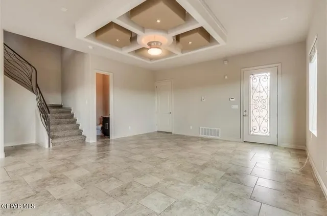 a view of an empty room with stairs