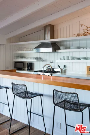 a kitchen with stainless steel appliances a stove a sink and cabinets