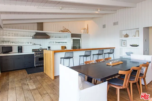 a kitchen with a table chairs and a stove