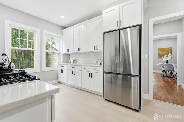 a kitchen with stainless steel appliances a refrigerator sink and cabinets