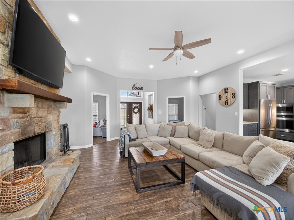 494 Flash Circle Luling, TX 78648 - Photo 8 of 44 a living room with furniture a flat screen tv and a fireplace