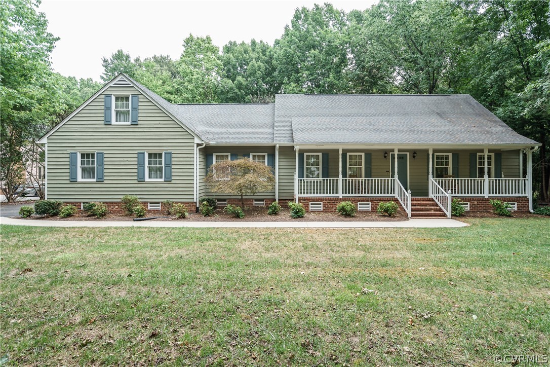 a front view of house with yard and green space
