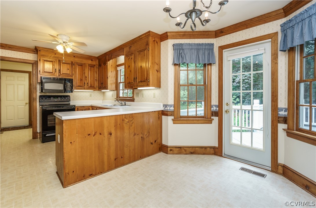 12901 Rivers Bend Road Chester, VA 23836 - Photo 12 of 29 a kitchen that has a lot of cabinets and wooden floor