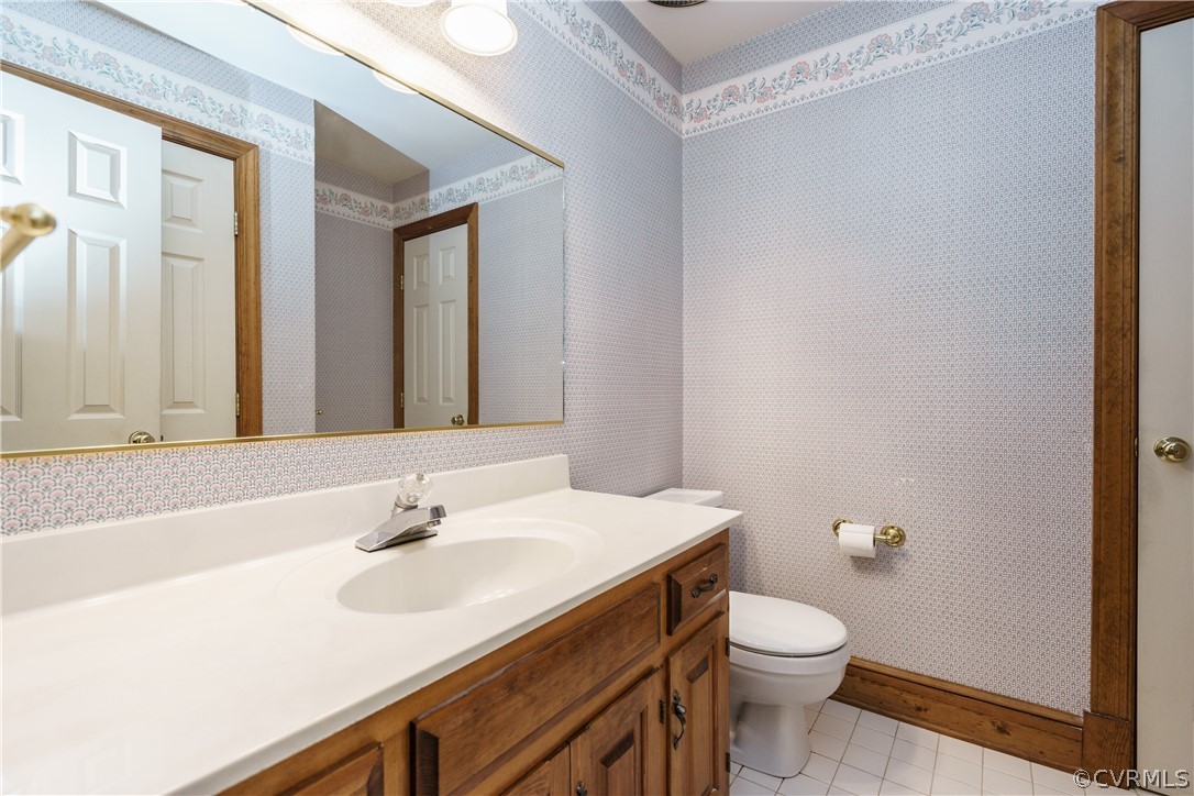12901 Rivers Bend Road Chester, VA 23836 - Photo 17 of 29 a bathroom with a sink a toilet and mirror