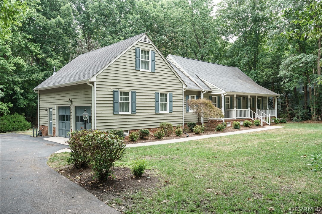 12901 Rivers Bend Road Chester, VA 23836 - Photo 2 of 29 a front view of a house with a yard