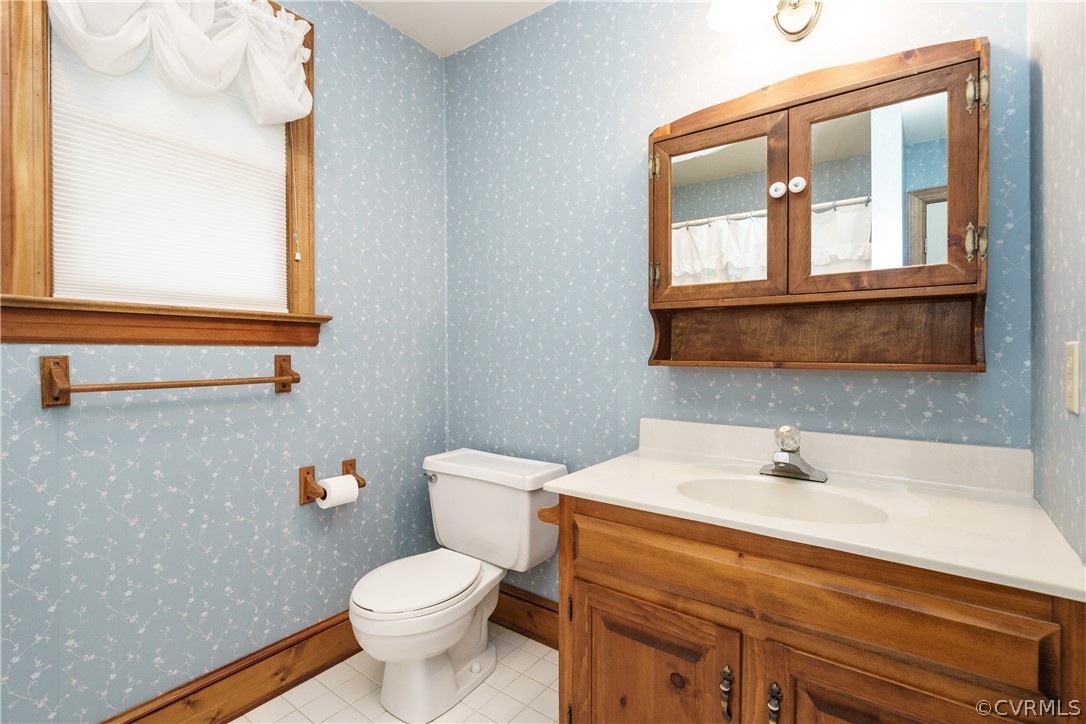 12901 Rivers Bend Road Chester, VA 23836 - Photo 23 of 29 a bathroom with a sink a mirror and a toilet