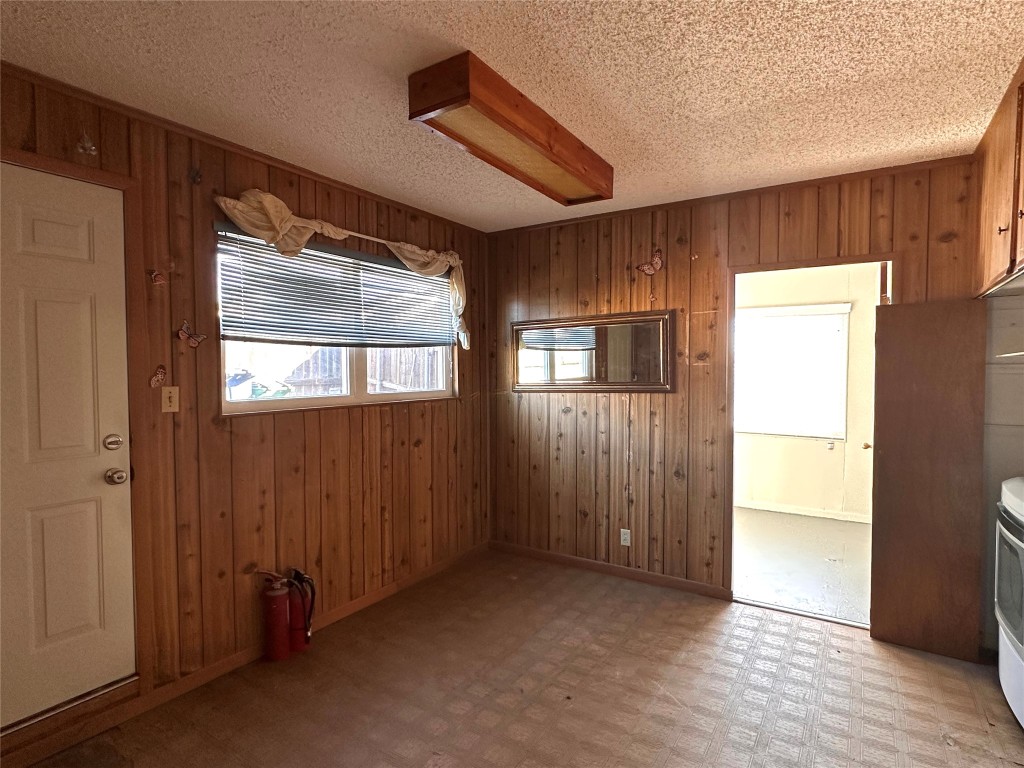 2500 Biggs Drive Austin, TX 78741 - Photo 17 of 23 a view of an empty room with wooden floor and a window