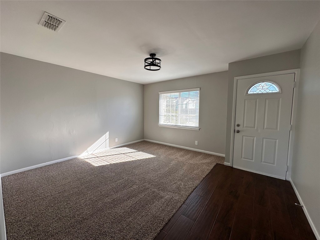 2500 Biggs Drive Austin, TX 78741 - Photo 5 of 23 a view of empty room with wooden floor and fan