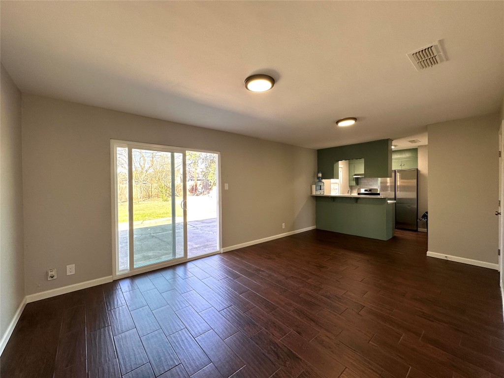 2500 Biggs Drive Austin, TX 78741 - Photo 6 of 23 a view of an empty room with wooden floor and a window