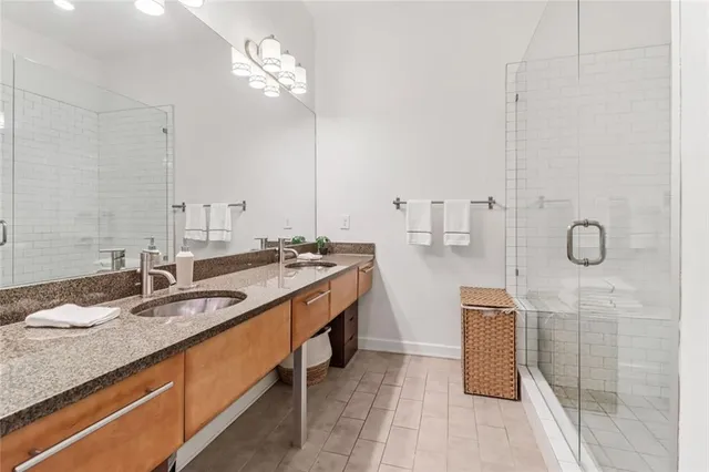 a bathroom with double vanity sink and a mirror