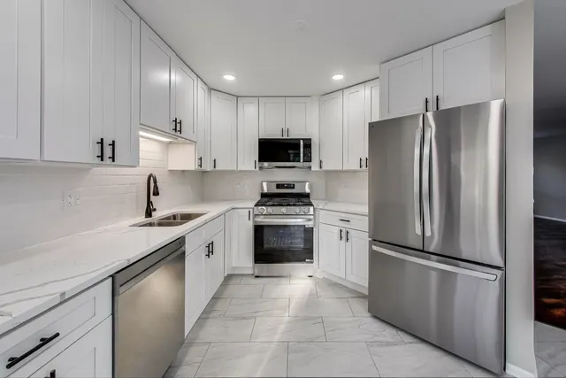a kitchen with a refrigerator sink and microwave