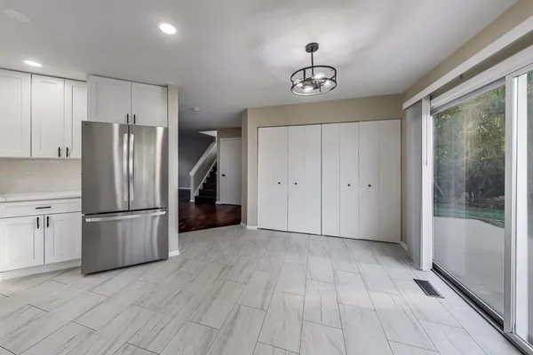 a view of a kitchen with a refrigerator a microwave and a sink