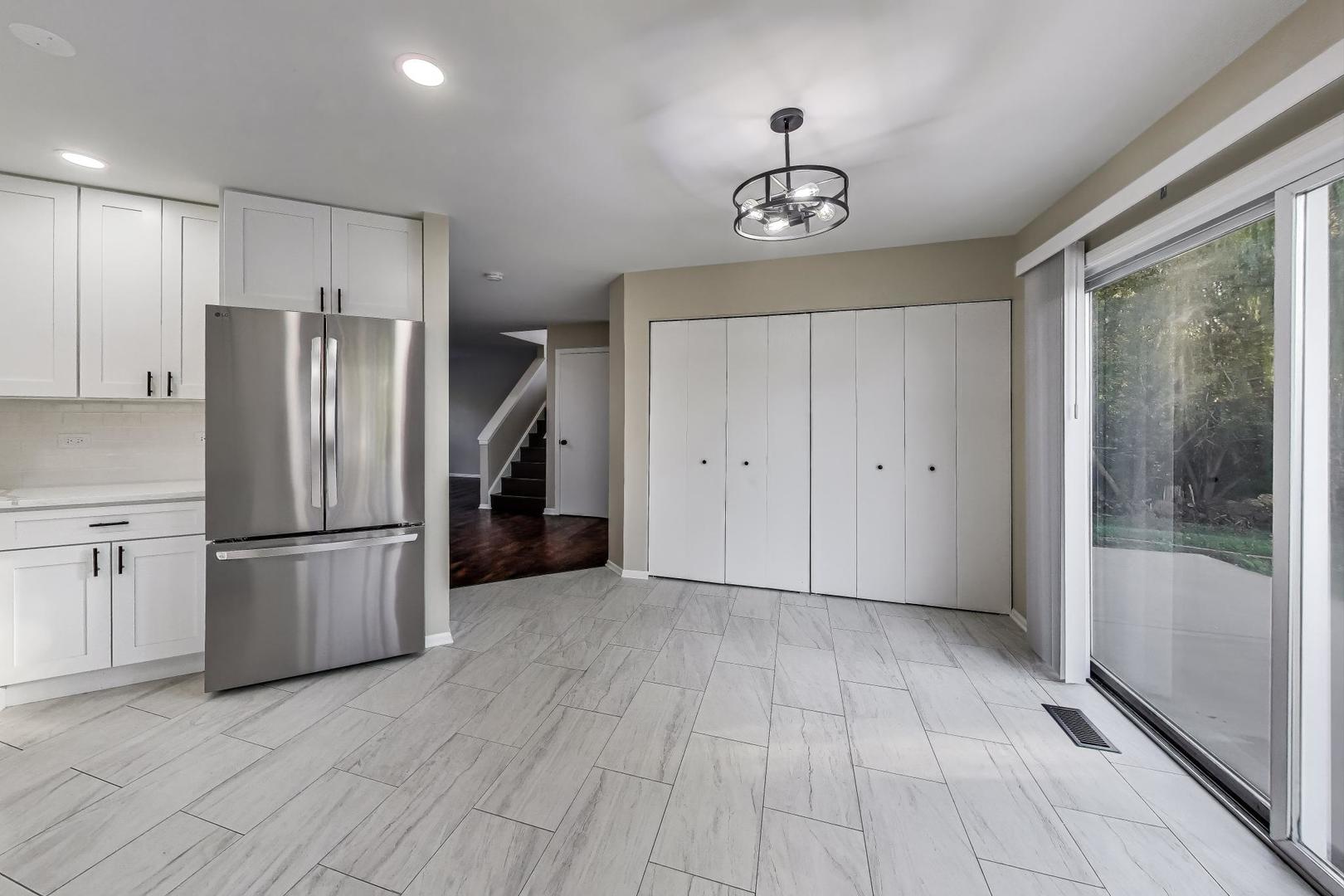 926 South W Avenue Waukegan, IL 60085 - Photo 13 of 45 a view of a kitchen with a refrigerator a microwave and a sink