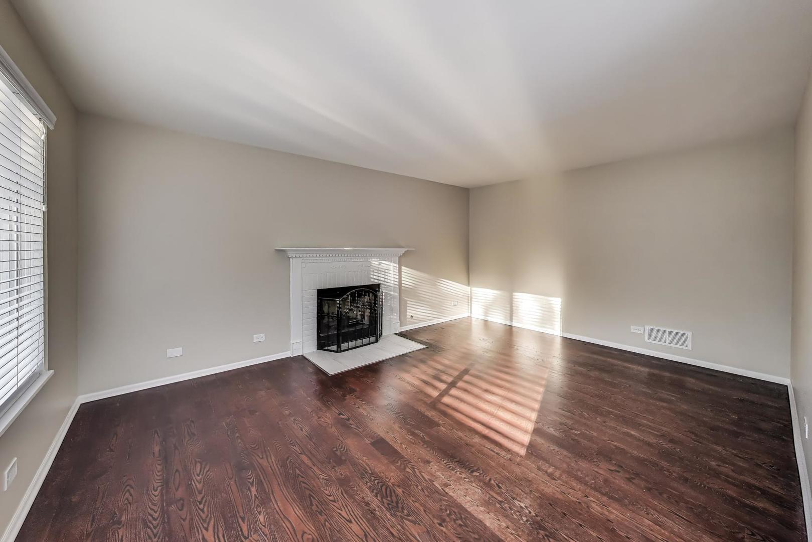 926 South W Avenue Waukegan, IL 60085 - Photo 14 of 45 a view of an empty room with wooden floor fireplace and a window