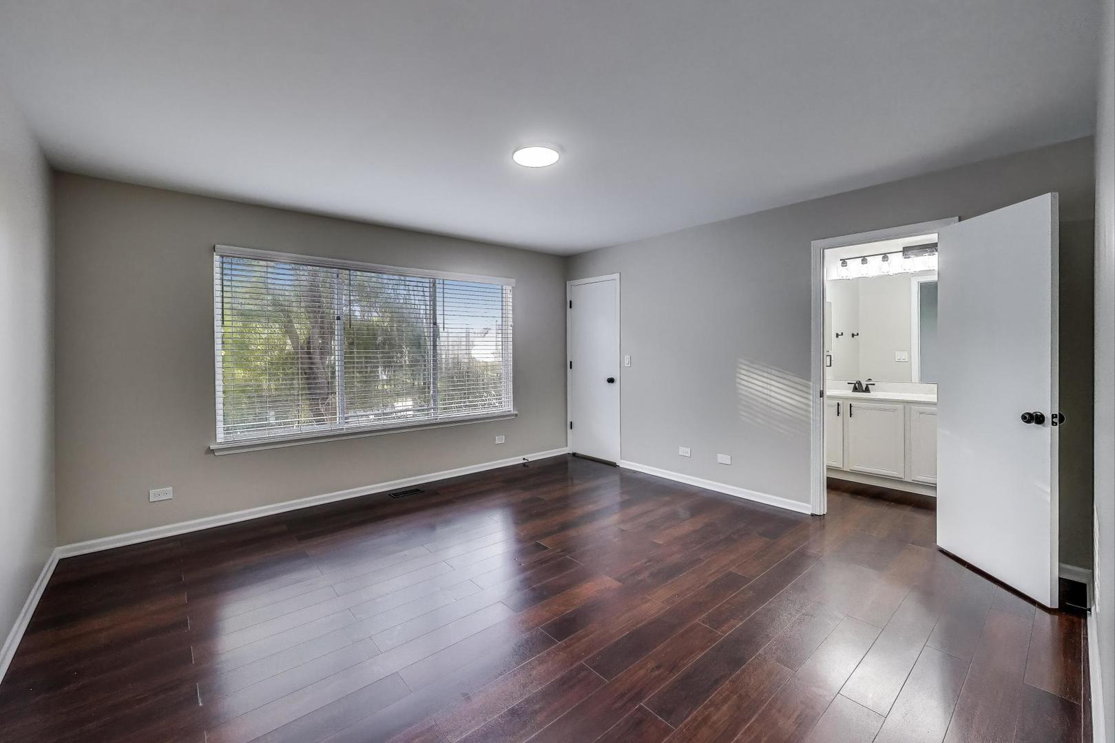 926 South W Avenue Waukegan, IL 60085 - Photo 17 of 45 an empty room with wooden floor and windows