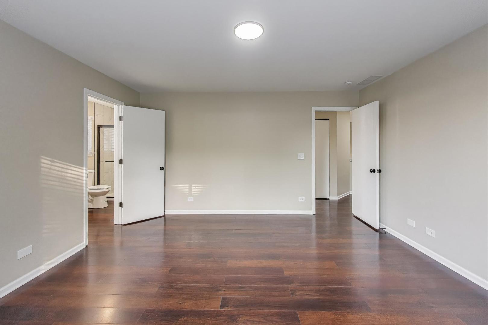926 South W Avenue Waukegan, IL 60085 - Photo 18 of 45 a view of an empty room with wooden floor and a window