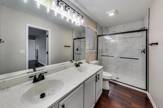 a bathroom with a sink double vanity and a mirror