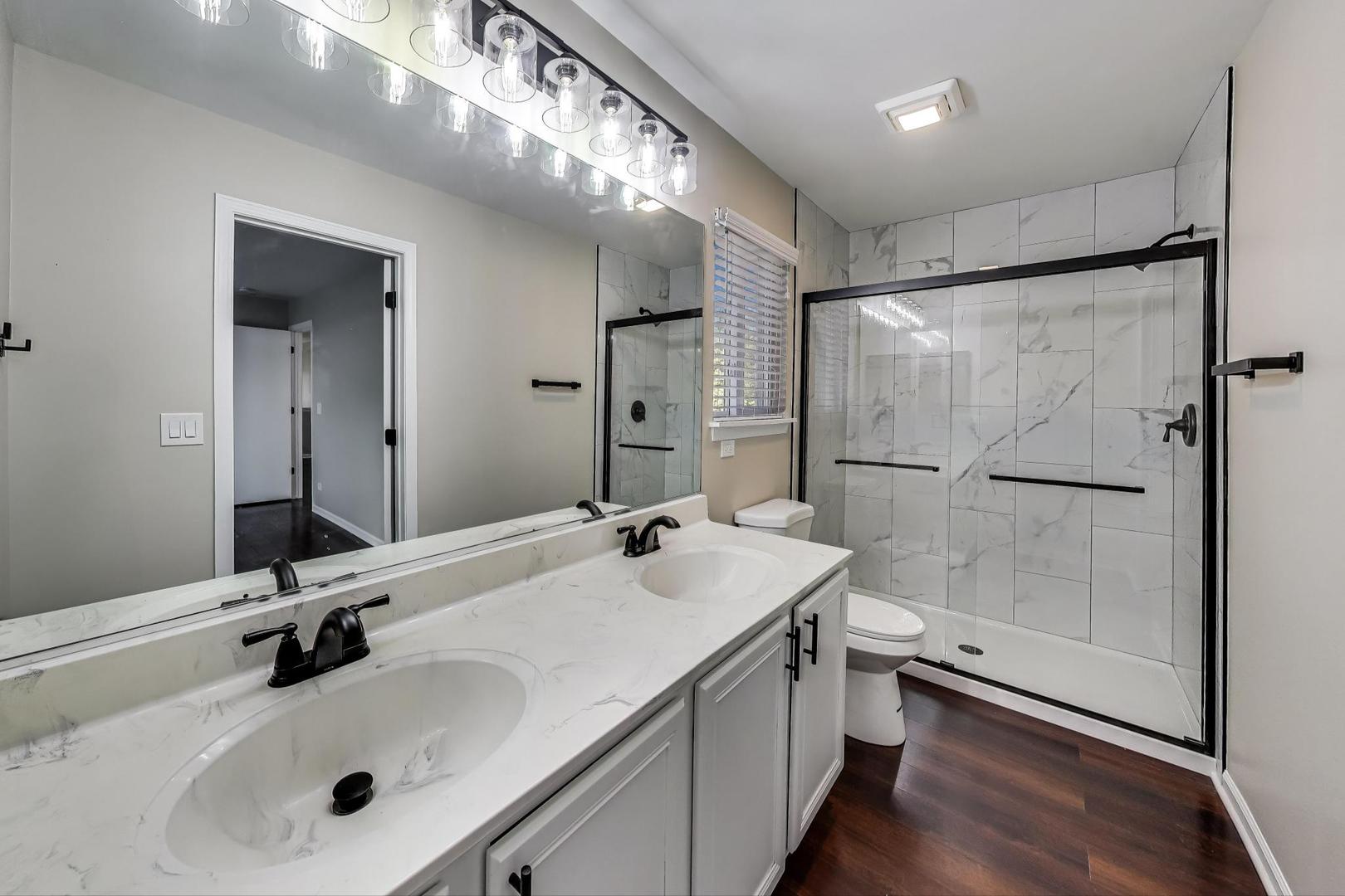 926 South W Avenue Waukegan, IL 60085 - Photo 20 of 45 a bathroom with a sink double vanity and a mirror