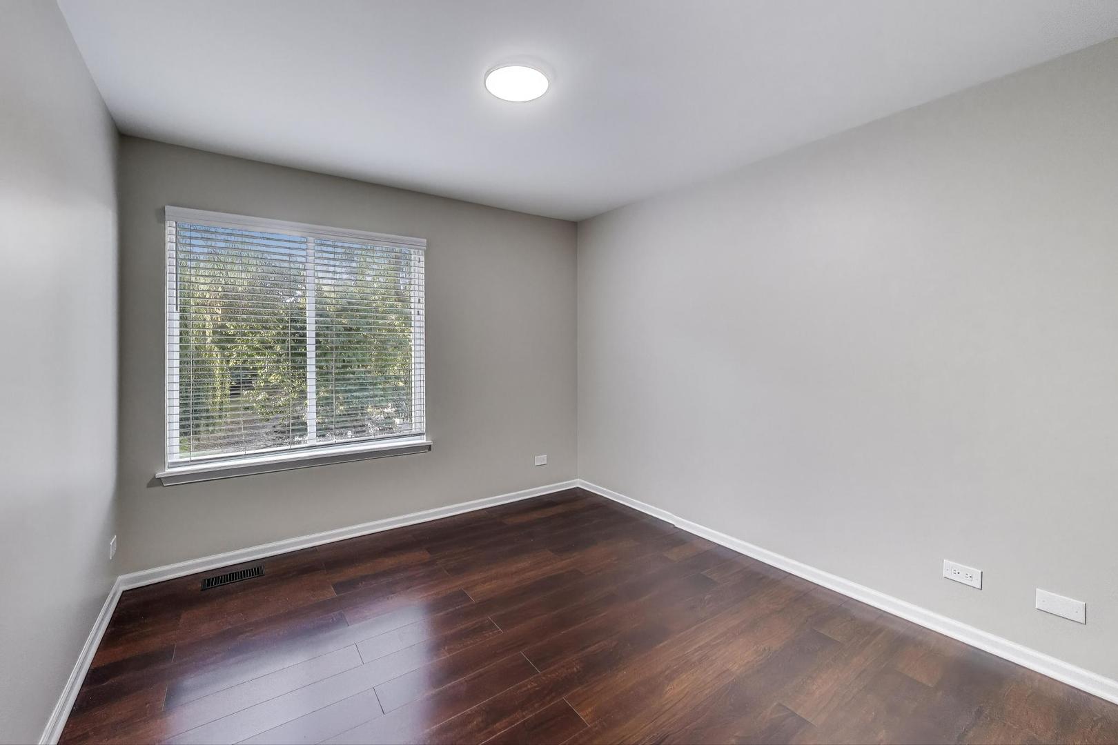 926 South W Avenue Waukegan, IL 60085 - Photo 23 of 45 an empty room with wooden floor and windows