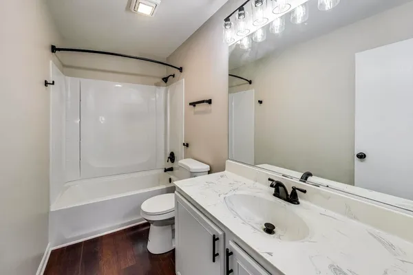 a bathroom with a sink toilet tub and shower