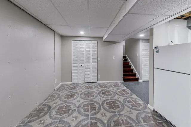 a view of a hallway with closet and wooden floor