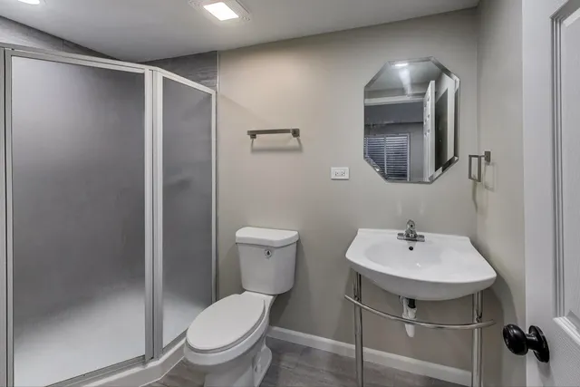 a bathroom with a toilet sink and mirror
