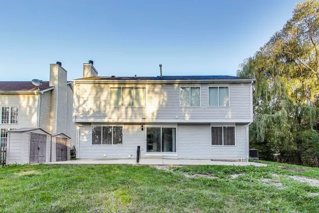 a front view of house with a garden