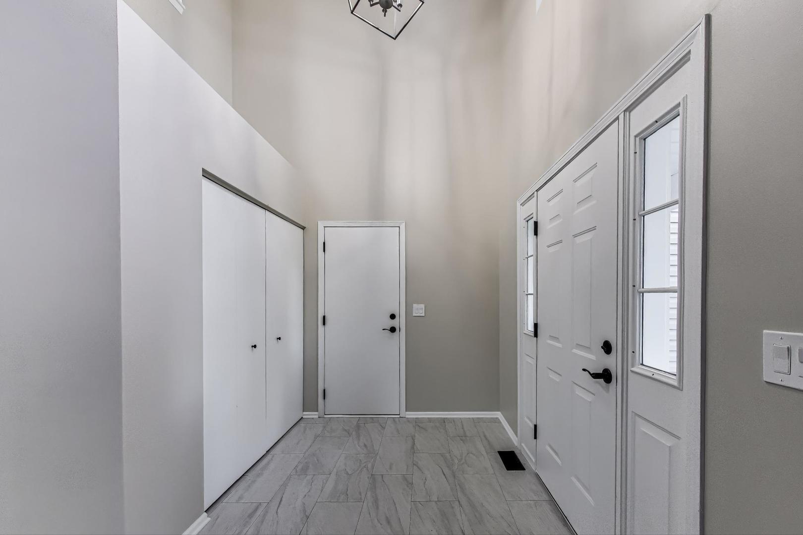 926 South W Avenue Waukegan, IL 60085 - Photo 4 of 45 a view of a hallway with wooden floor and entryway