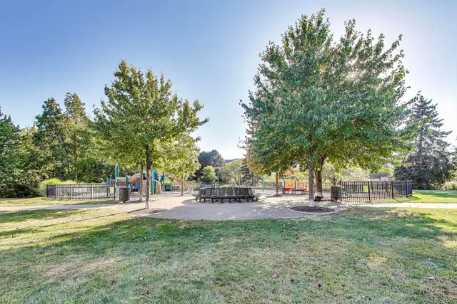 a view of park with swings and slides