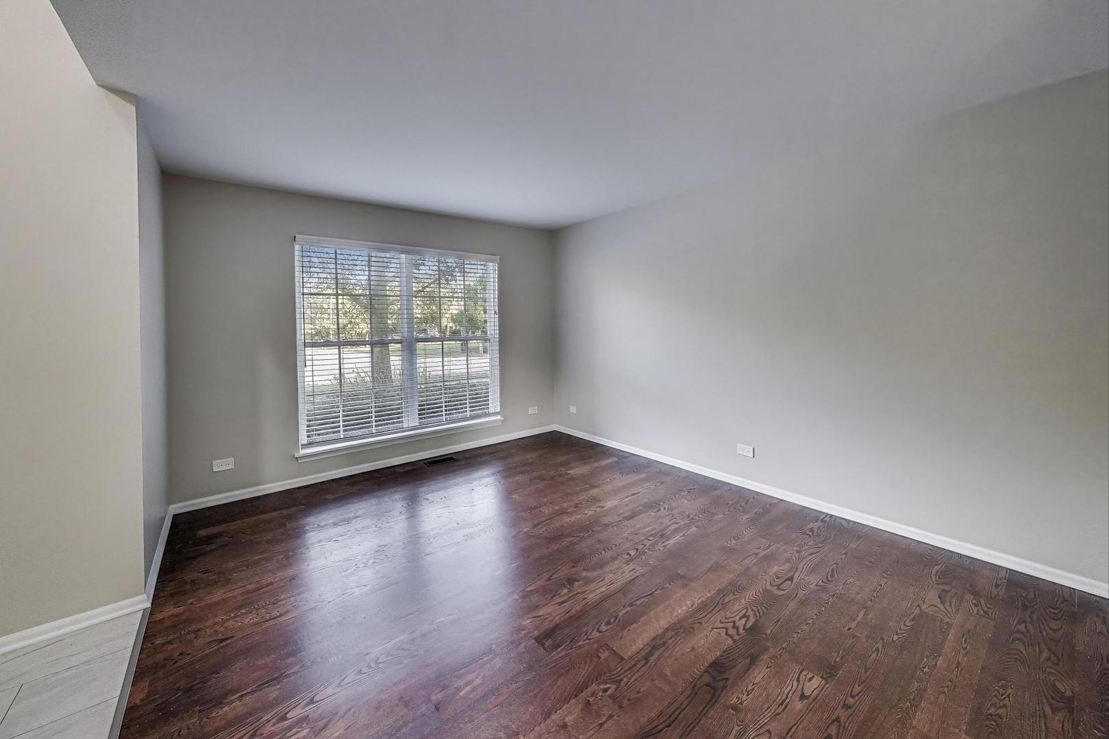 926 South W Avenue Waukegan, IL 60085 - Photo 7 of 45 a view of an empty room with wooden floor and a window