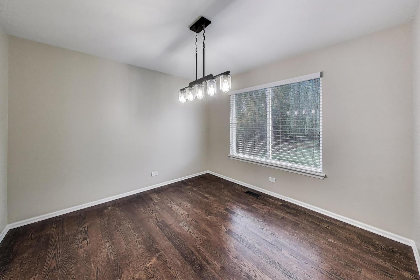 926 South W Avenue Waukegan, IL 60085 - Photo 8 of 45 a view of an empty room with wooden floor and a window
