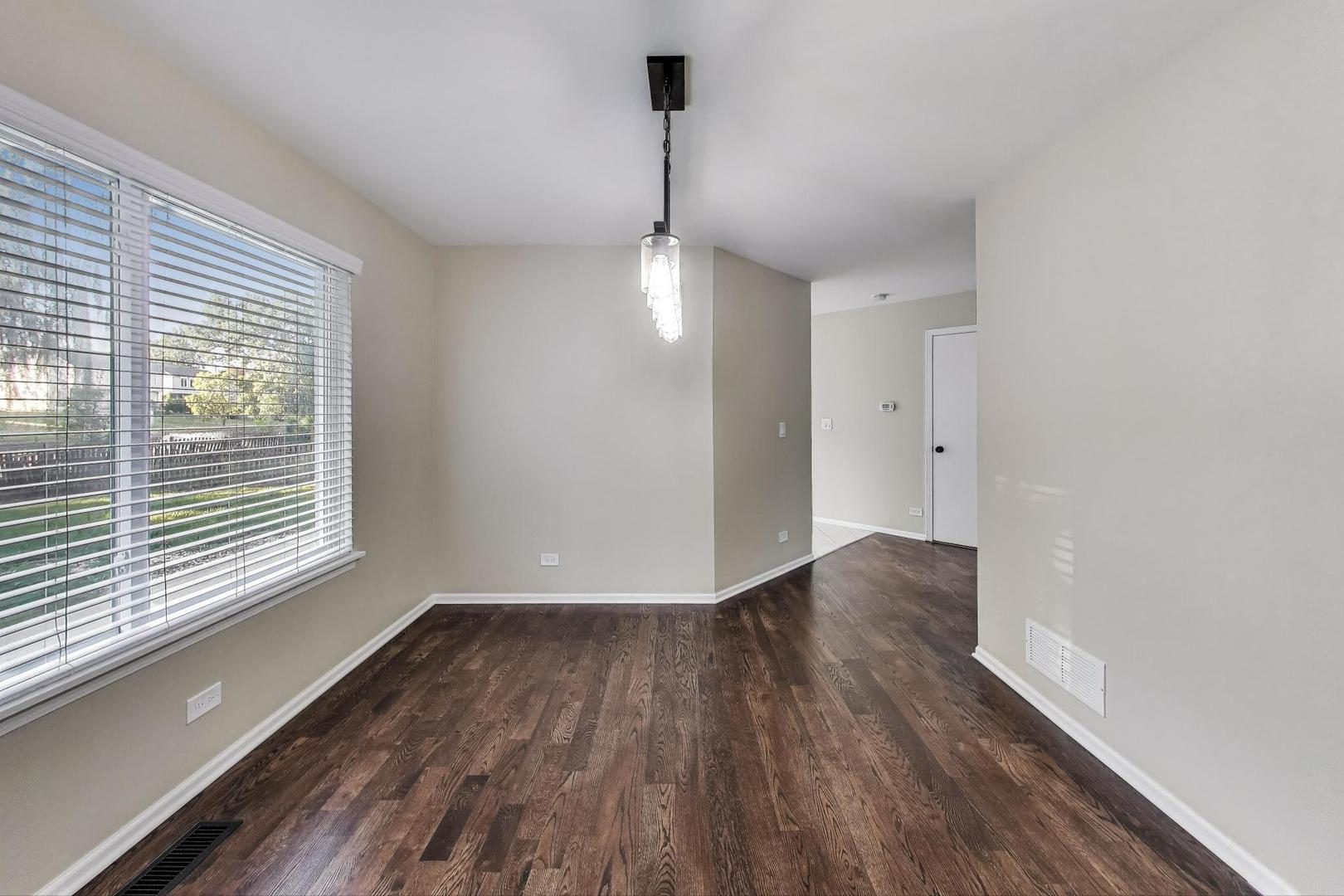 926 South W Avenue Waukegan, IL 60085 - Photo 9 of 45 a view of an empty room with wooden floor and a window