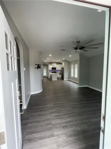 a view of livingroom with hardwood floor and a hallway
