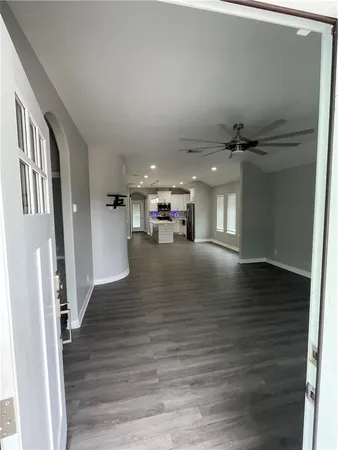 a view of livingroom with hardwood floor and a hallway