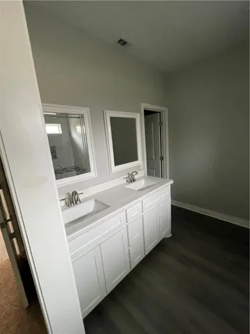 a bathroom with a double vanity sink and mirror
