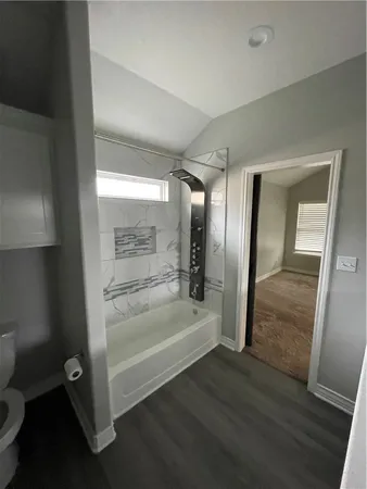 a bathroom with a tub and shower