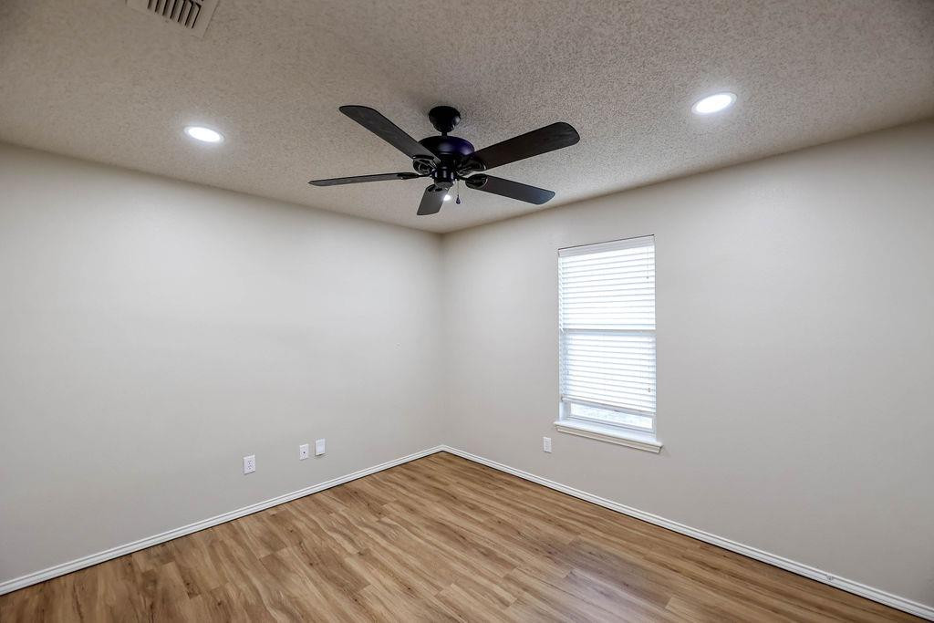 6536 7th Street Lubbock, TX 79416 - Photo 15 of 23 wooden floor in an empty room with a window