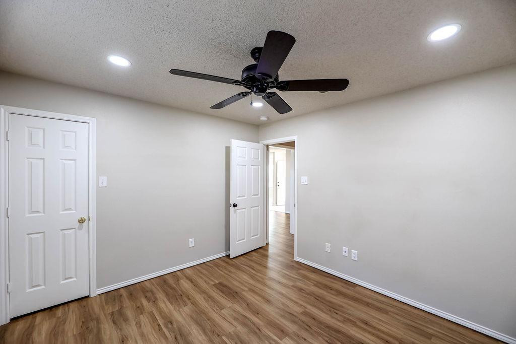 6536 7th Street Lubbock, TX 79416 - Photo 17 of 23 wooden floor in an empty room with a window