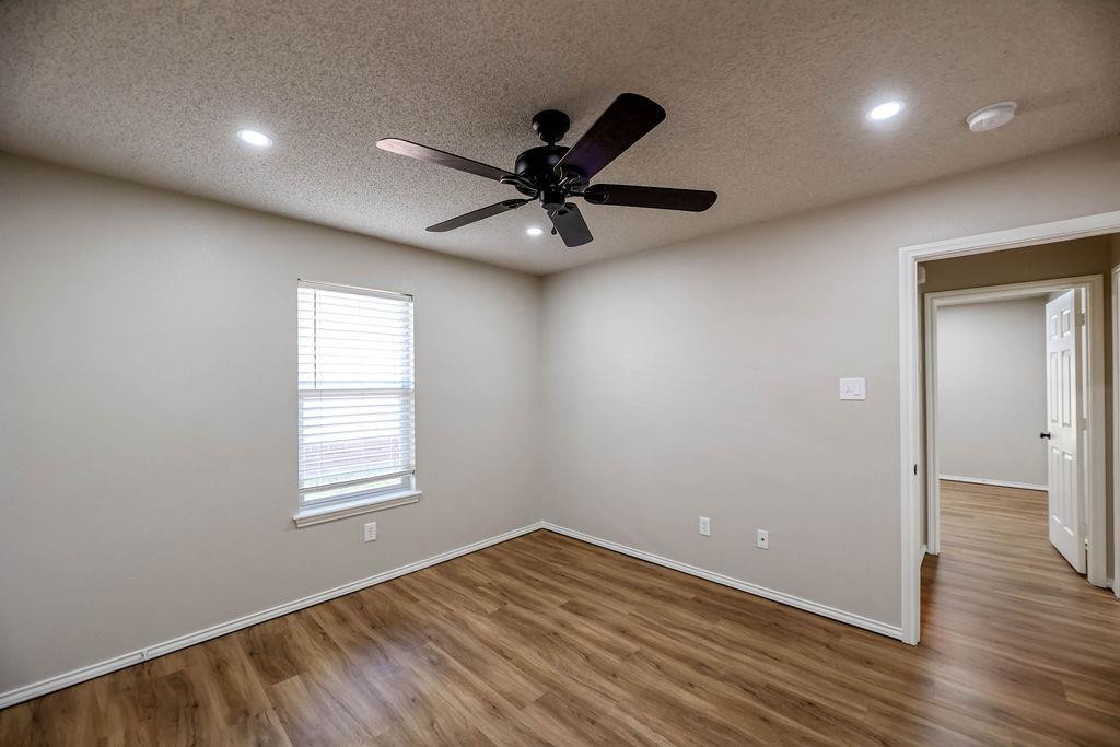 6536 7th Street Lubbock, TX 79416 - Photo 20 of 23 wooden floor in an empty room with a window