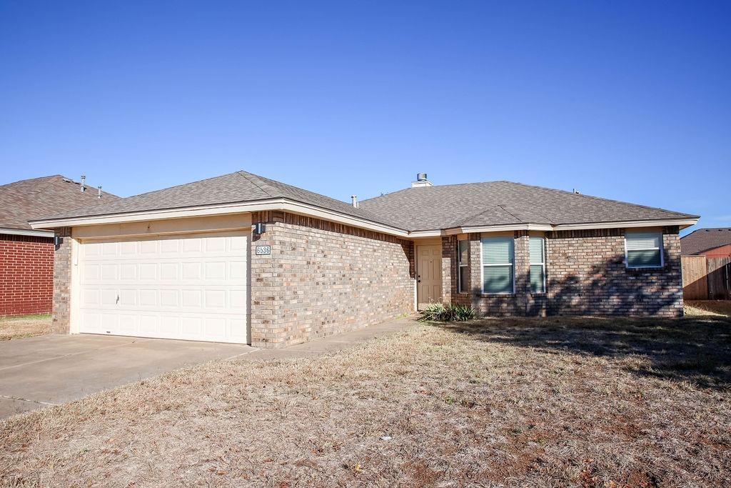 6536 7th Street Lubbock, TX 79416 - Photo 2 of 23 a front view of a house with a yard
