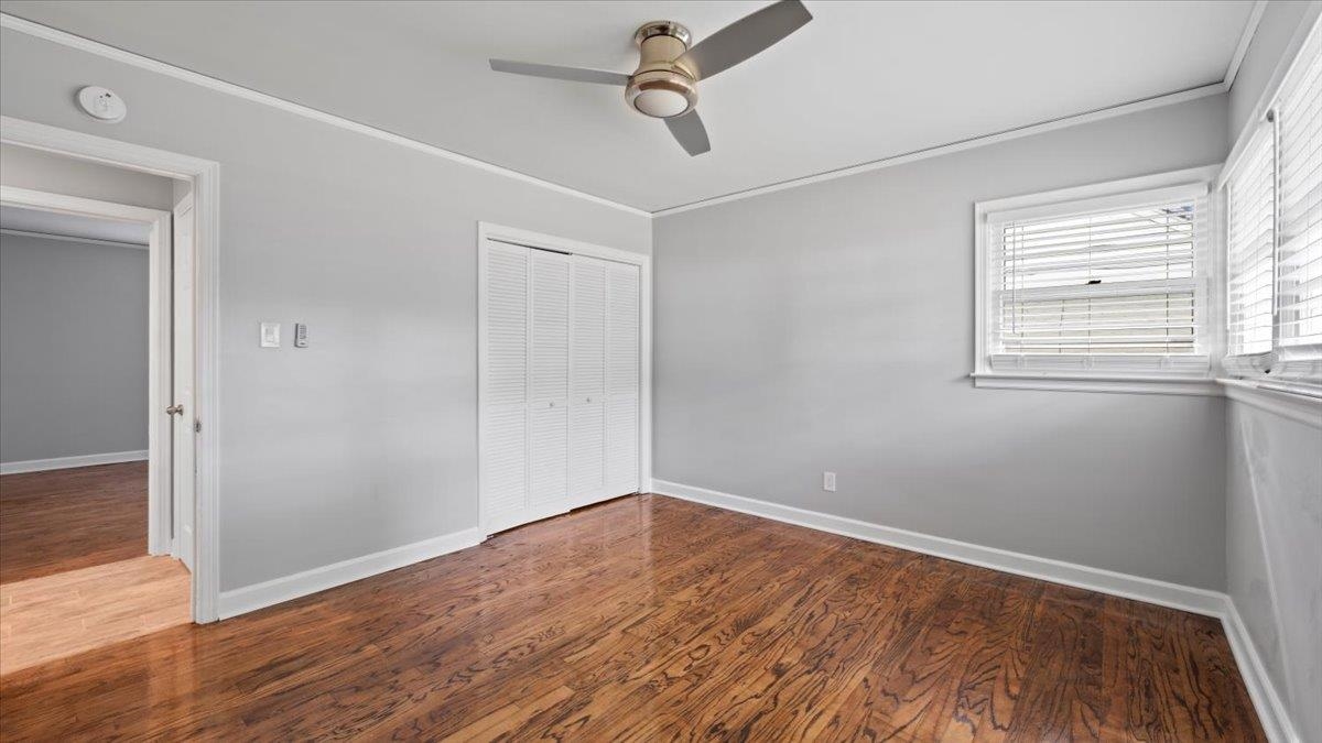 176 North Rose Road Memphis, TN 38117 - Photo 16 of 24 an empty room with wooden floor closet and windows