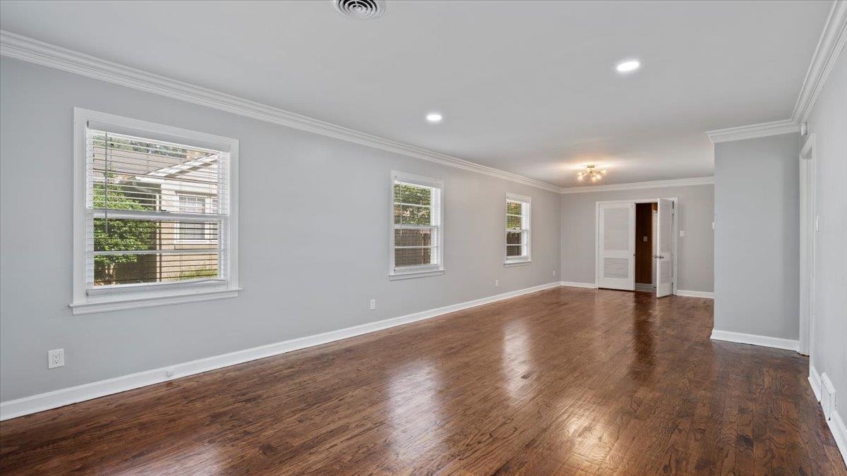 176 North Rose Road Memphis, TN 38117 - Photo 2 of 24 a view of an empty room with wooden floor and a window