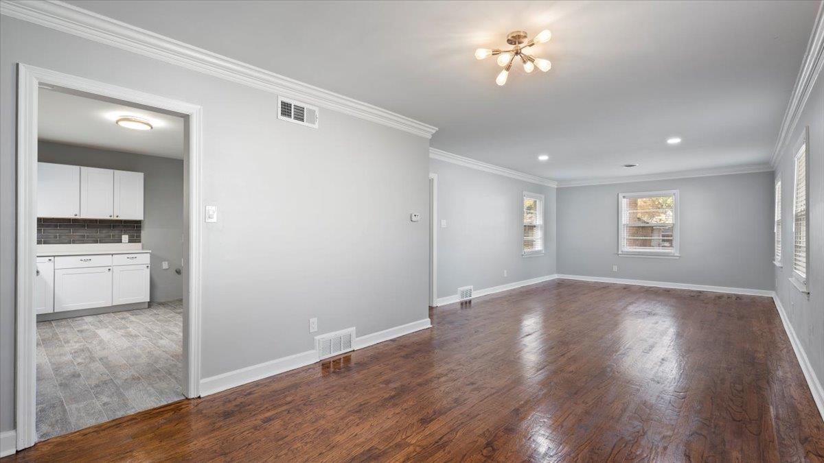 176 North Rose Road Memphis, TN 38117 - Photo 4 of 24 a view of empty room with wooden floor and kitchen view