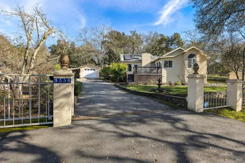 a view of a house with wooden fence