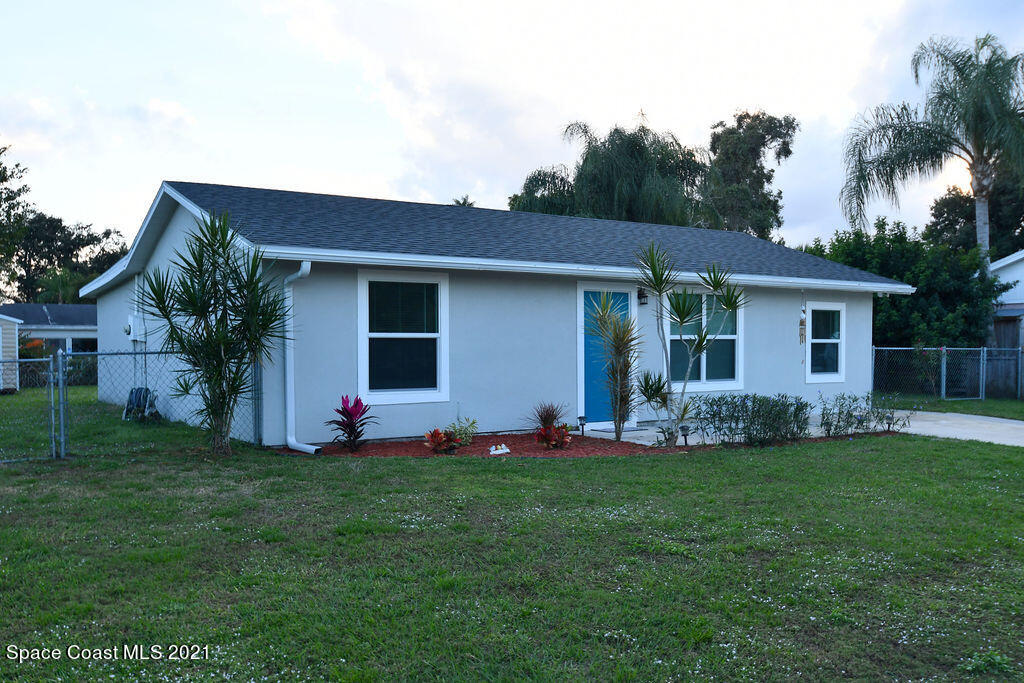 1461 Creel Road Northeast Palm Bay, FL 32905 - Photo 1 of 20 a front view of house with yard and green space