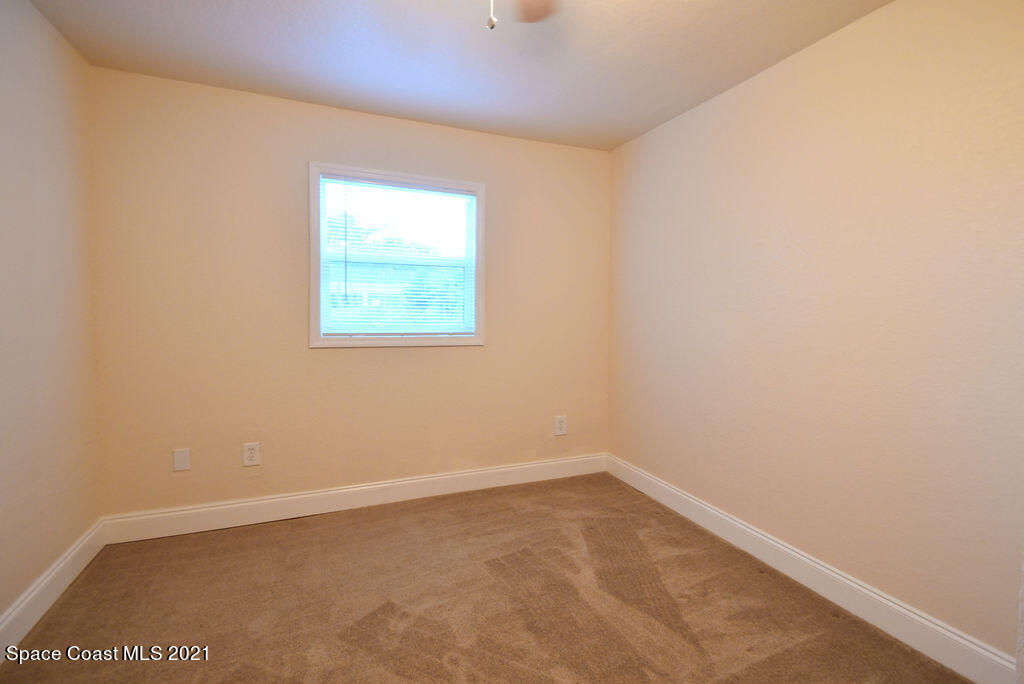 1461 Creel Road Northeast Palm Bay, FL 32905 - Photo 12 of 20 an empty room with a window