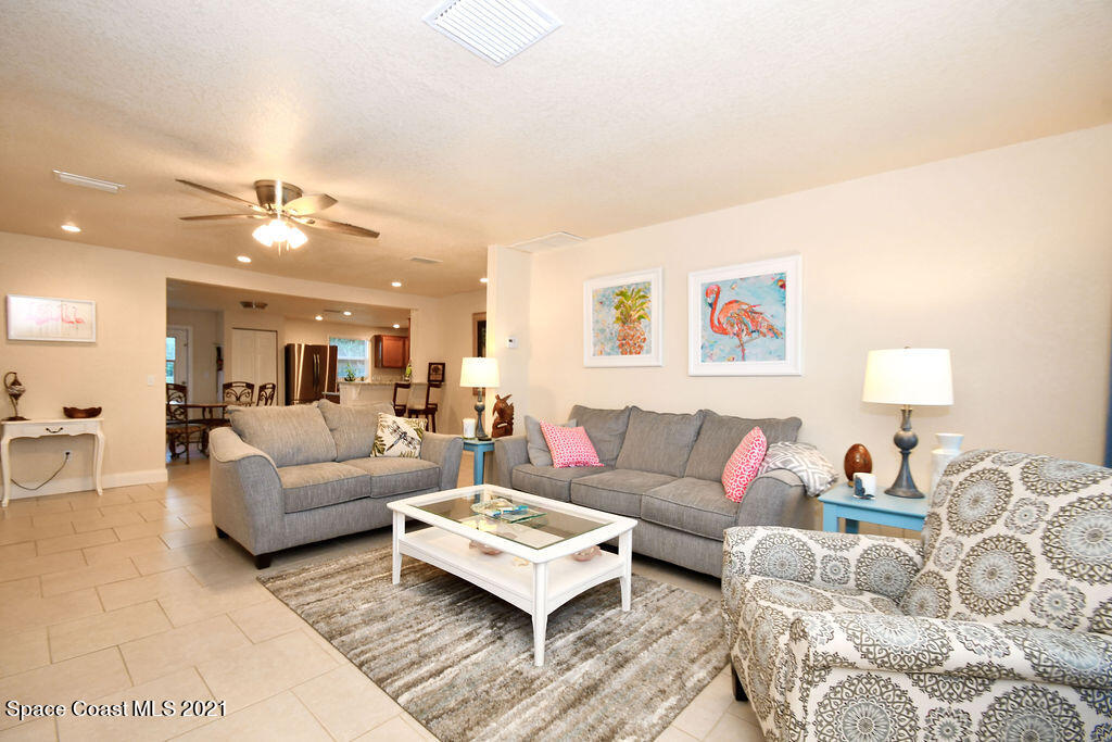 1461 Creel Road Northeast Palm Bay, FL 32905 - Photo 5 of 20 a living room with furniture and a ceiling fan